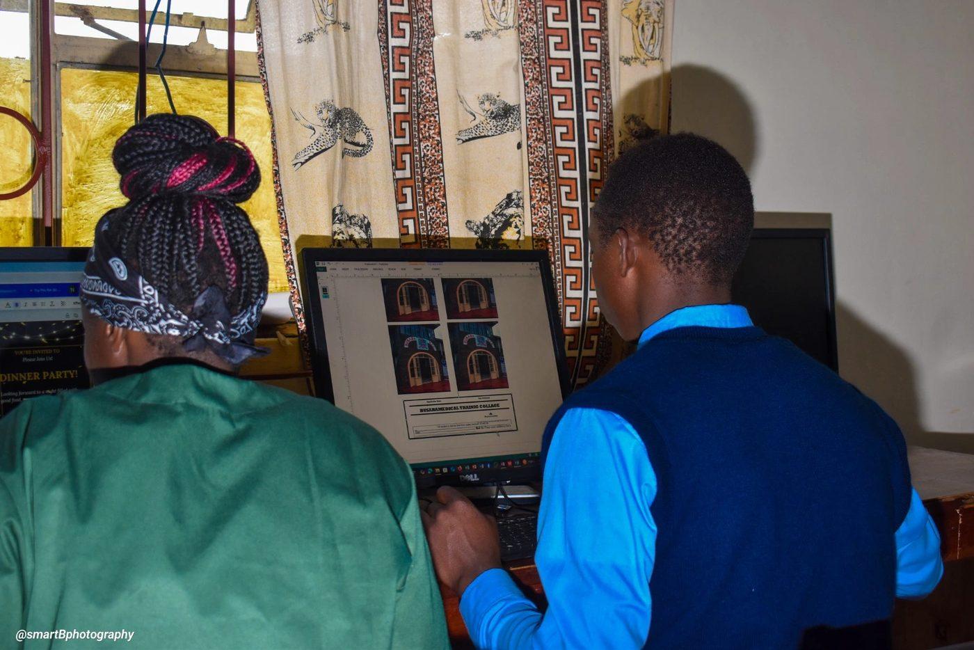 Two students working at a computer in the ICT lab